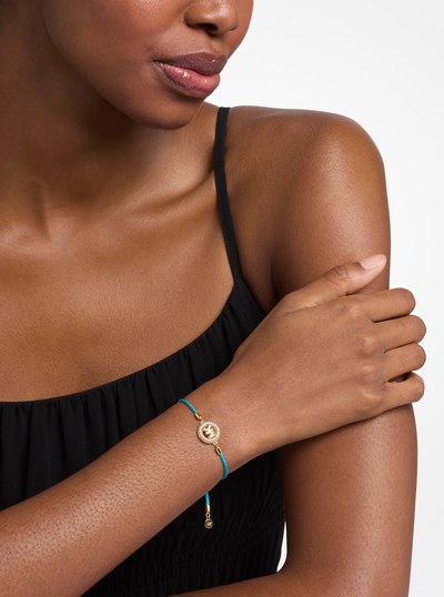 Pav&eacute; Gold-Tone Logo Corded Bracelet in TURQUOISE | Michael Kors