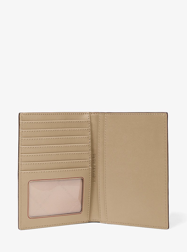 Jet Set Medium Metallic Logo Debossed Passport Wallet in PALE GOLD | Michael Kors