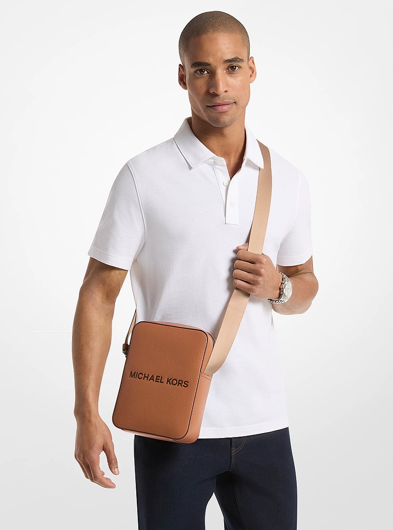 Cooper Logo Embossed Pebbled Leather Messenger Bag in LUGGAGE | Michael Kors