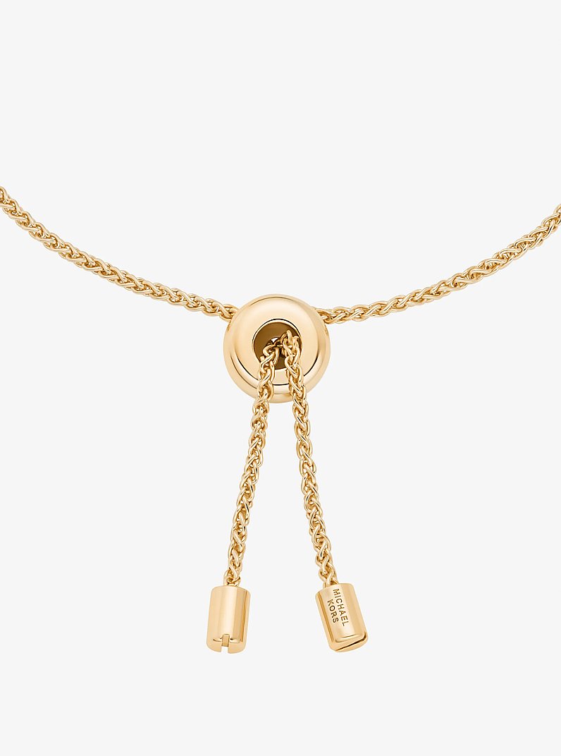 Pulsera deslizante con colgante con logotipo con pav&eacute; in DORADO | Michael Kors