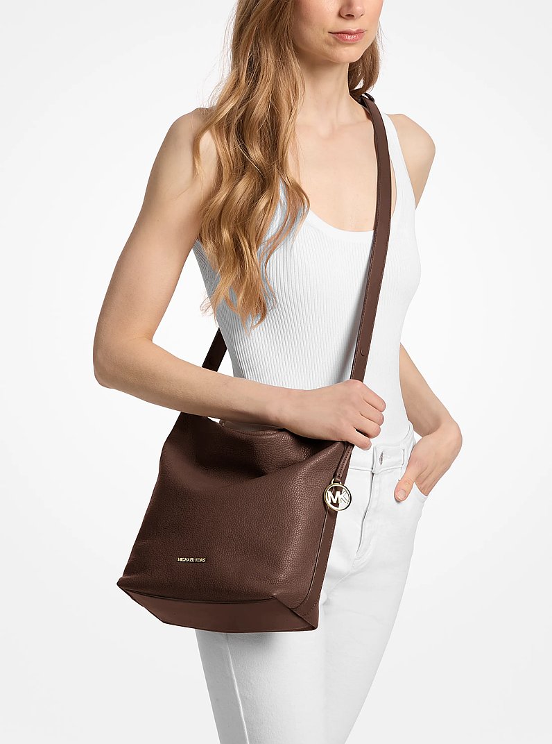 Roey Medium Pebbled Leather Bucket Messenger Bag in NUTMEG | Michael Kors