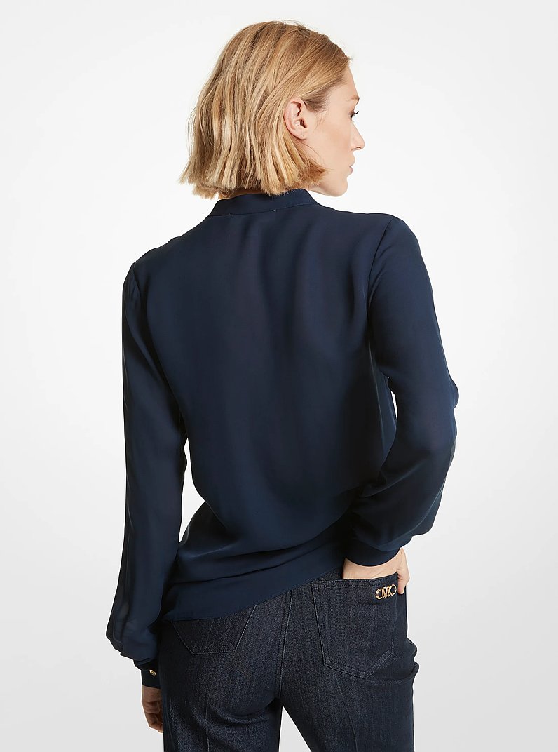 Blusa in georgette a pieghe con volant