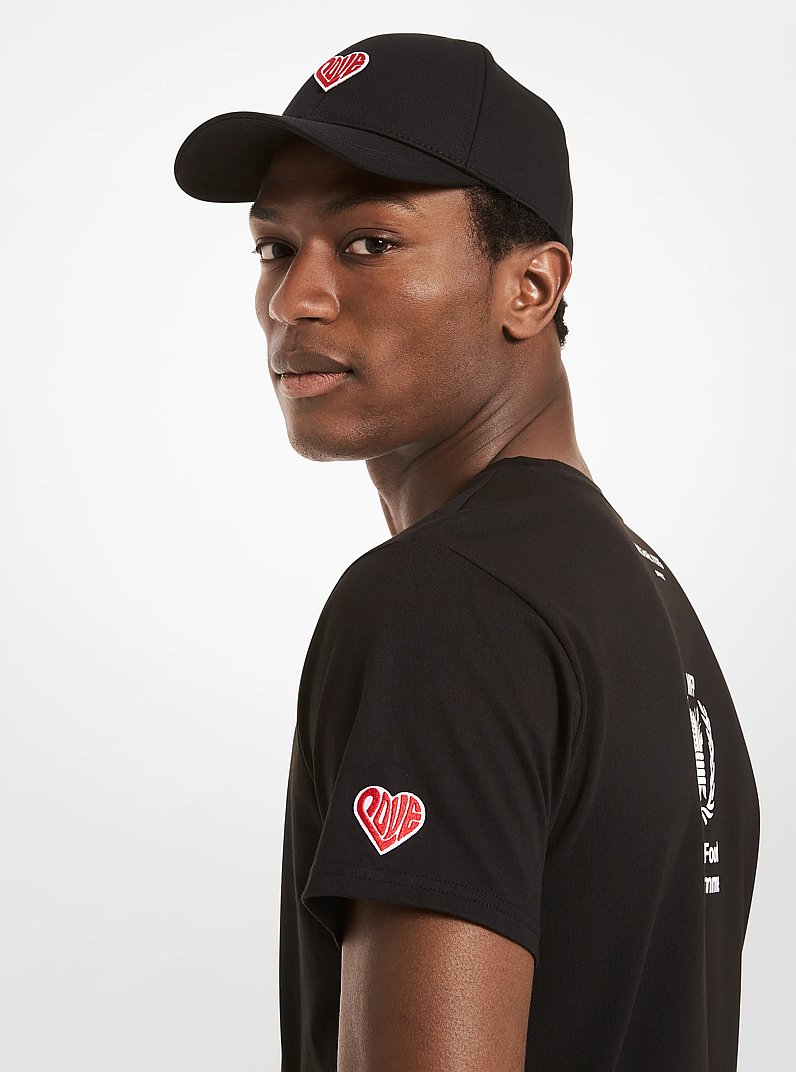Gorra de b&eacute;isbol Watch Hunger Stop LOVE de algod&oacute;n org&aacute;nico in NEGRO | Michael Kors