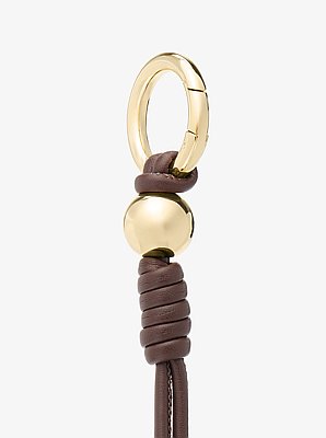 Colgante para bolso con nudo en tono dorado
